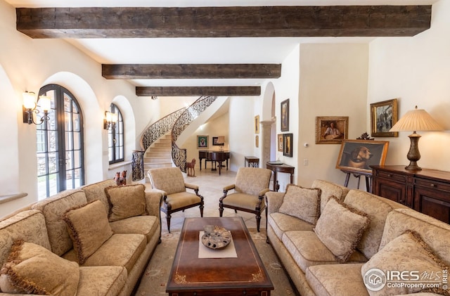 living room with french doors, carpet, and beam ceiling