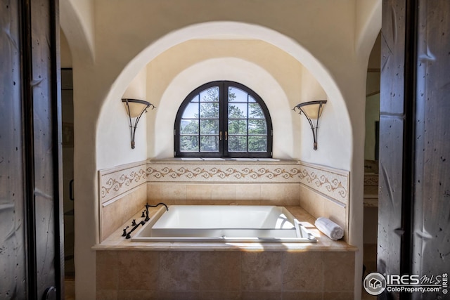 bathroom with tiled bath