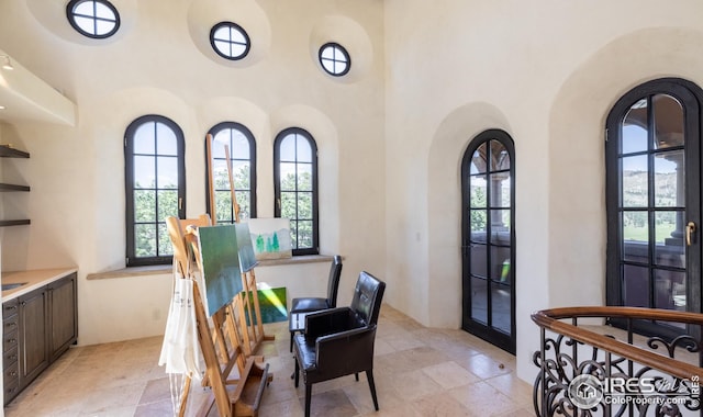 dining room featuring a towering ceiling