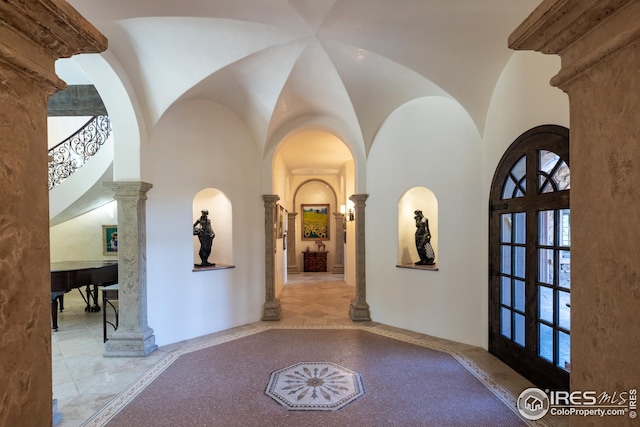 entrance foyer with lofted ceiling and decorative columns