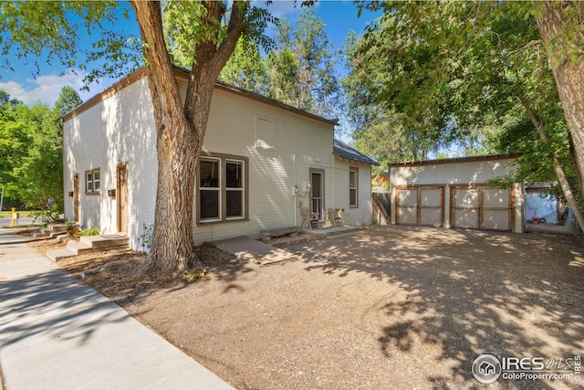 back of house with an outbuilding and a garage