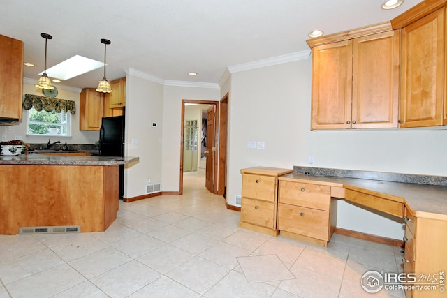 kitchen with pendant lighting, sink, light tile patterned flooring, and black fridge