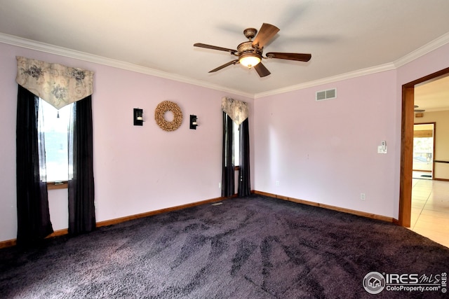 unfurnished room with ornamental molding, carpet, and ceiling fan