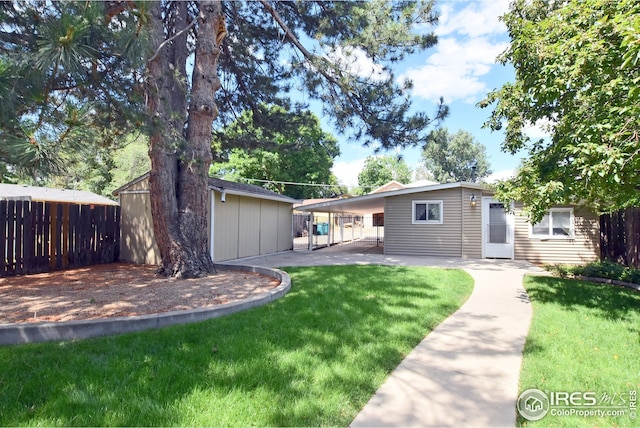 rear view of house featuring a carport and a lawn