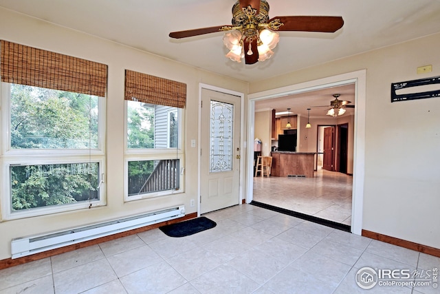 doorway with a baseboard radiator, light tile patterned floors, and ceiling fan