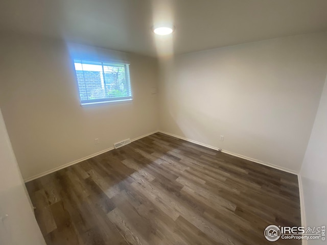 empty room featuring dark wood-type flooring