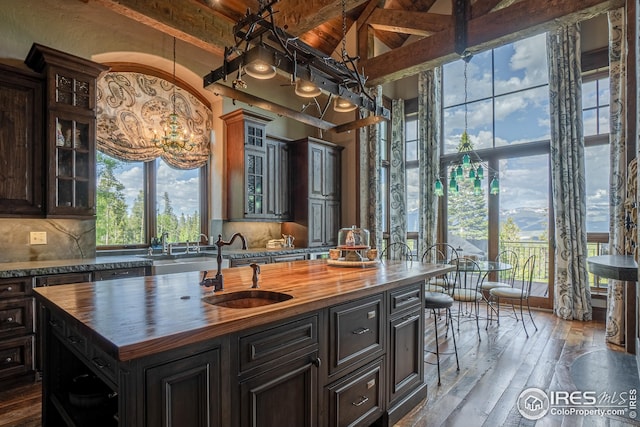 300 Samaia Ct, Tabernash, CO 80478 - kitchen with wooden counters, a sink, a center island with sink, and decorative backsplash