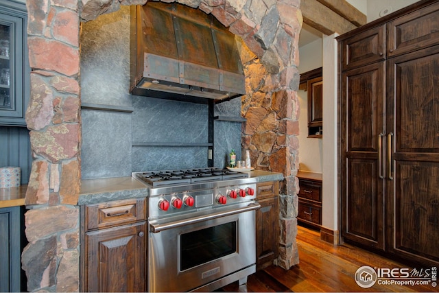 300 Samaia Ct, Tabernash, CO 80478 - kitchen with dark brown cabinetry, dark wood-type flooring, premium range, light countertops, and backsplash