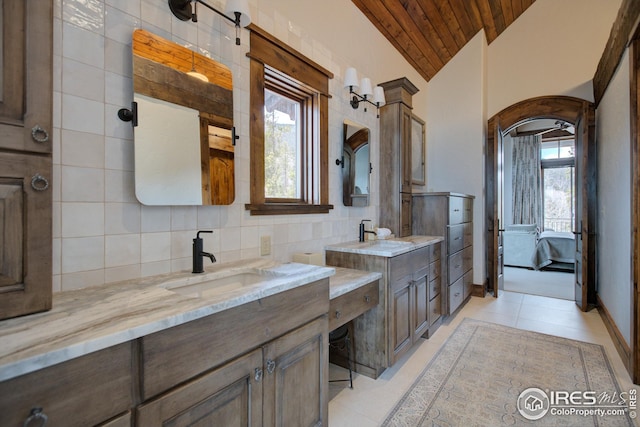 300 Samaia Ct, Tabernash, CO 80478 - ensuite bathroom with tasteful backsplash, plenty of natural light, vaulted ceiling, and a sink