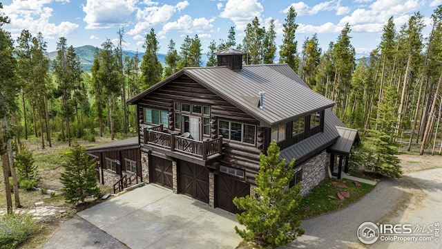 300 Samaia Ct, Tabernash, CO 80478 - view of front of property with a standing seam roof, metal roof, a garage, stone siding, and driveway