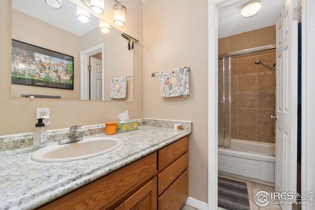 bathroom with tile patterned floors, vanity, and combined bath / shower with glass door