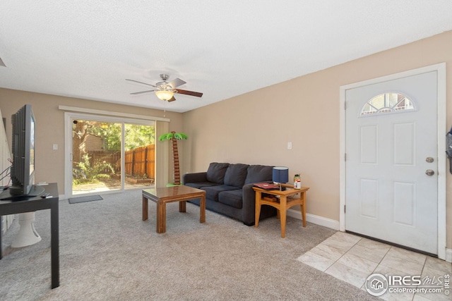 carpeted living room with a textured ceiling and ceiling fan