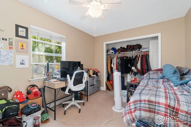 carpeted bedroom featuring ceiling fan, a textured ceiling, and a closet