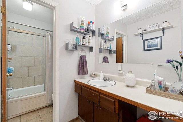 bathroom featuring tile patterned floors, shower / tub combo, vanity, and a textured ceiling