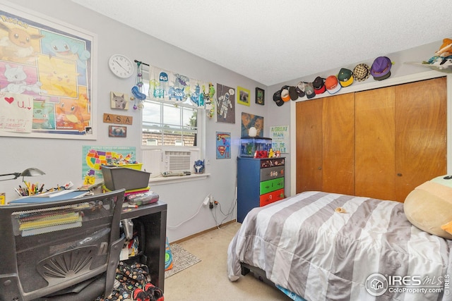 carpeted bedroom featuring a closet and a textured ceiling