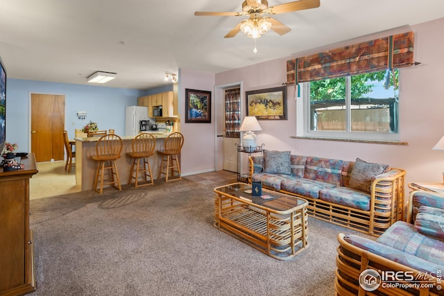 carpeted living room featuring ceiling fan