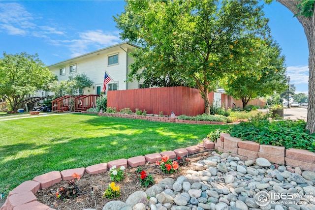 view of yard featuring stairway, fence, and a wooden deck