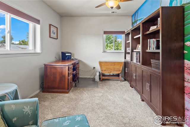 home office with light carpet and ceiling fan