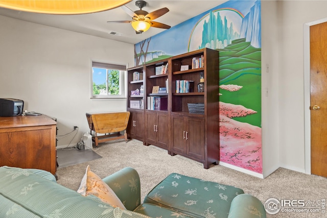 carpeted office space with ceiling fan