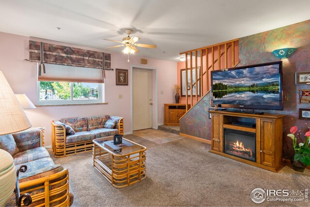 carpeted living room featuring ceiling fan