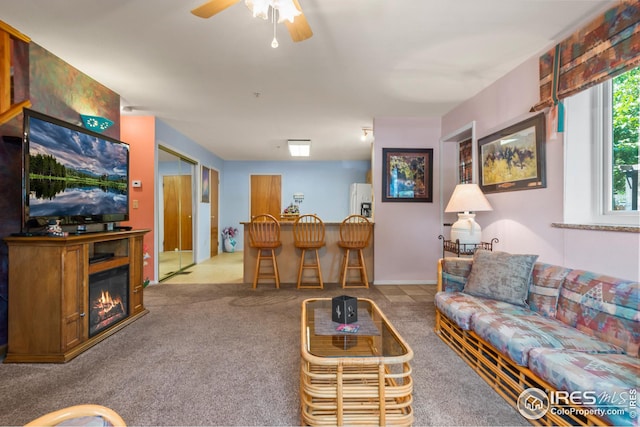 carpeted living room featuring ceiling fan