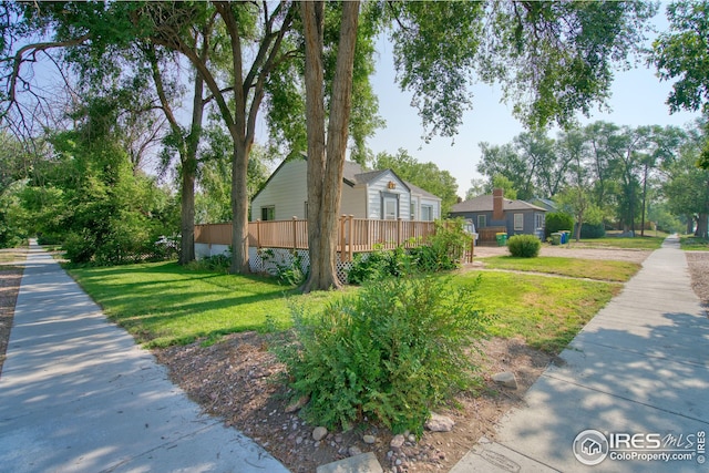 view of home's exterior with a lawn and a wooden deck