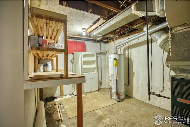 unfinished below grade area featuring water heater