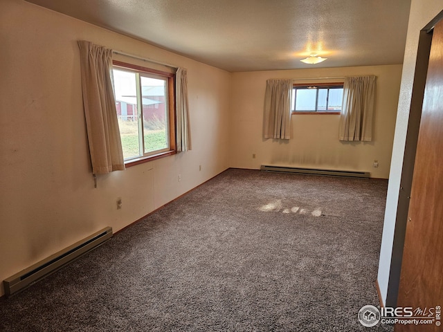 unfurnished room with a baseboard heating unit, a textured ceiling, and carpet flooring