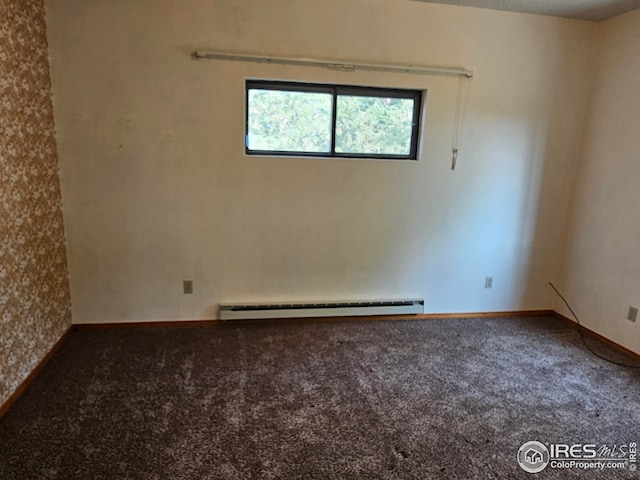 empty room featuring carpet flooring and baseboard heating