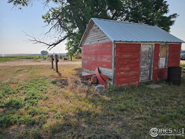 view of outdoor structure with a rural view