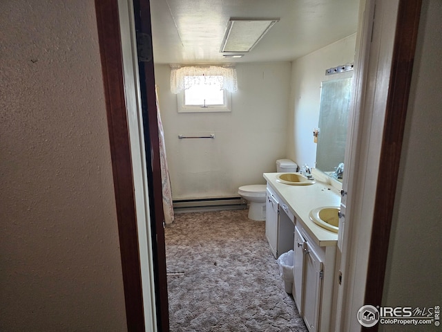 bathroom featuring vanity, a baseboard heating unit, and toilet