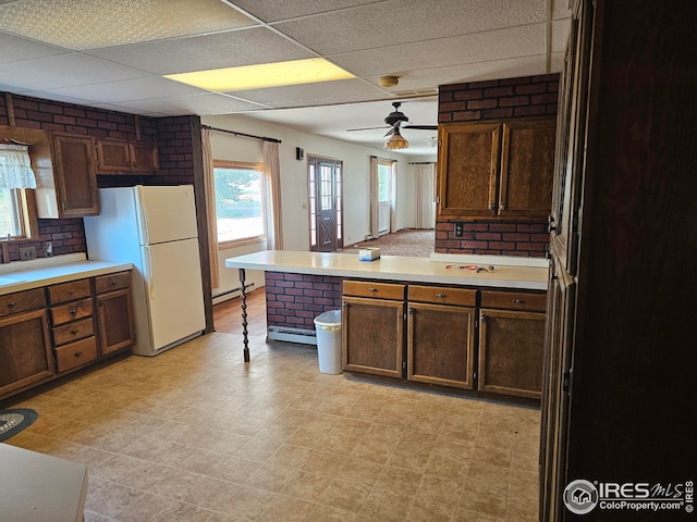 kitchen featuring white refrigerator, a drop ceiling, stainless steel fridge, and baseboard heating