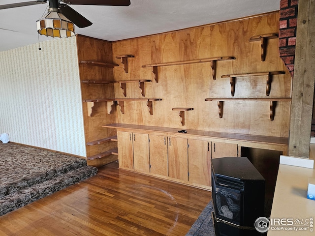 kitchen with ceiling fan and dark hardwood / wood-style flooring