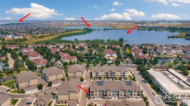 drone / aerial view featuring a water view and a residential view