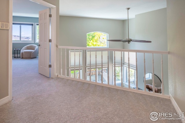 hall with light colored carpet and plenty of natural light