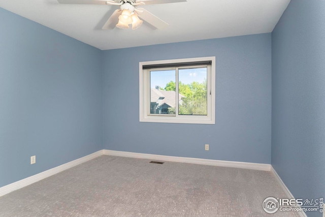 spare room featuring carpet flooring and ceiling fan