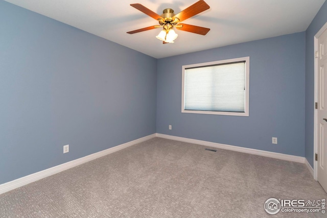 spare room with carpet and ceiling fan