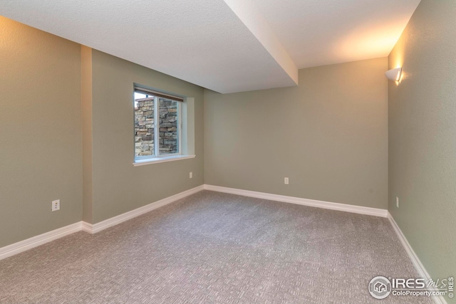 empty room featuring carpet floors and a textured ceiling