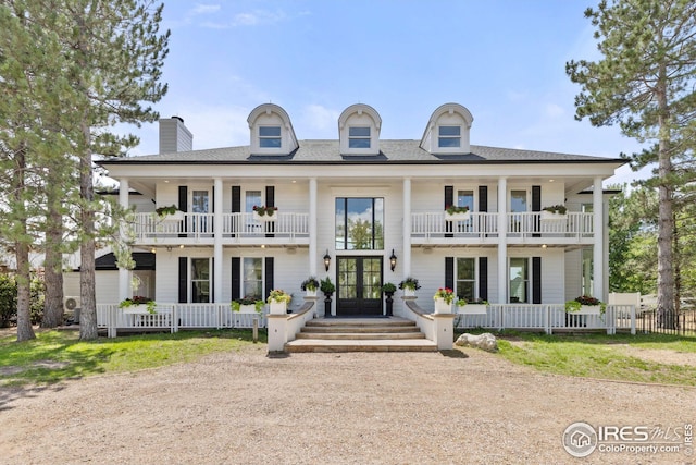 view of front of house featuring a porch, french doors, and a balcony