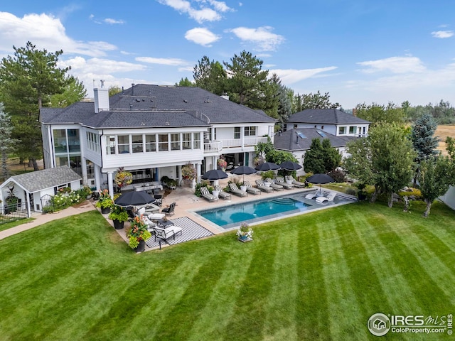 rear view of property with a patio and a yard