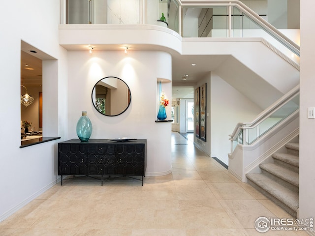 interior space featuring tile patterned flooring and a towering ceiling