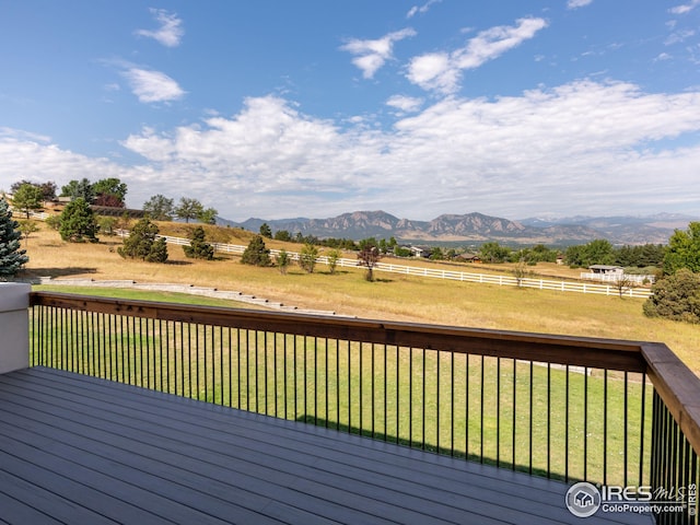 wooden terrace with a lawn and a mountain view