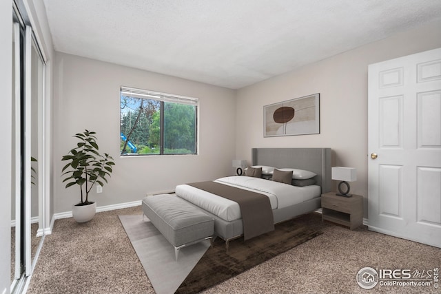 carpeted bedroom featuring a textured ceiling