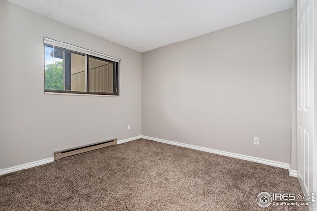 carpeted spare room with a textured ceiling and a baseboard radiator