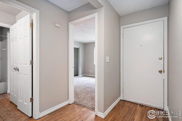 entrance foyer with a textured ceiling and hardwood / wood-style flooring