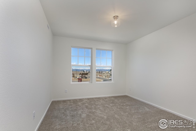 empty room with carpet flooring and baseboards