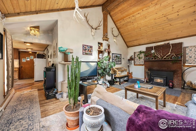 living area with beam ceiling, a brick fireplace, wood finished floors, high vaulted ceiling, and wooden ceiling