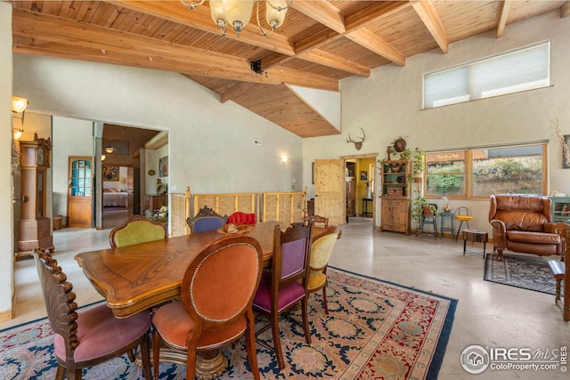 dining area with wooden ceiling, a towering ceiling, and beam ceiling