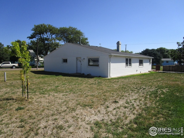 rear view of house with a yard