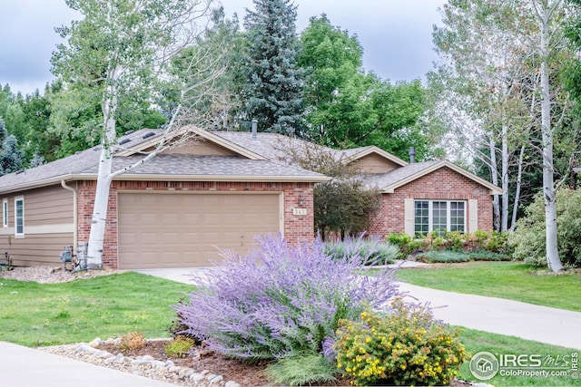 single story home with a garage and a front lawn